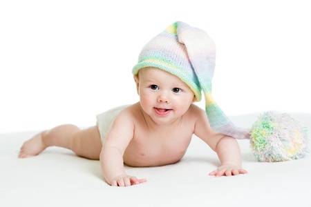 smiling baby weared diaper in funny hatの写真素材