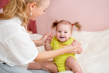 Happy mother  and baby have fun pastime at home