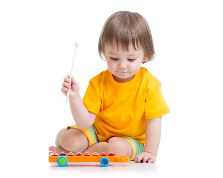 smiling child boy playing with musical toyの写真素材