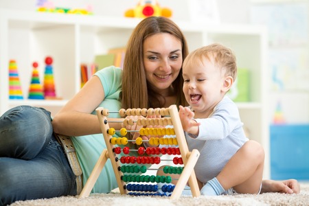 kid boy playing with abacus indoor at homeの写真素材