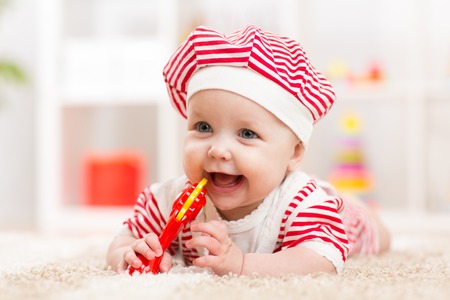 Cute baby child girl in hat having funの写真素材