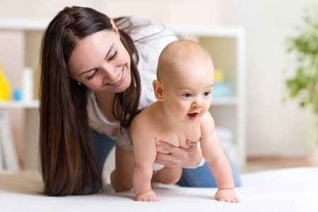 Funny crawling baby weared diaper with mother