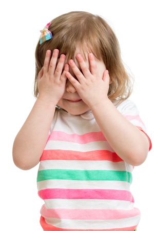 child hiding face by hands isolated on whiteの写真素材