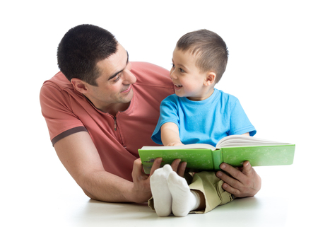 Daddy and kid son read together isolated on whiteの写真素材