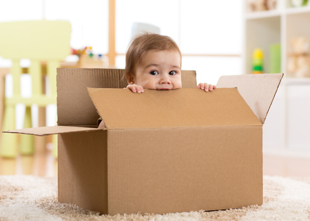 pretty baby infant boy sitting inside a boxの写真素材
