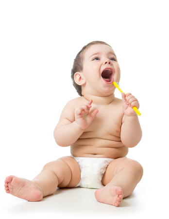 Cute child brushing teeth and smile, isolated over white.の写真素材