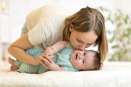 Happy loving family. Mom playing with her baby.の写真素材