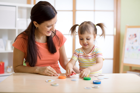Mom with creative child daughter having fun time togetherの写真素材