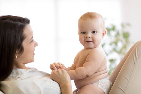 happy mother playing with newborn babyの写真素材