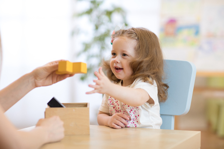 Smart child girl with didactic toys in preschool or daycareの写真素材
