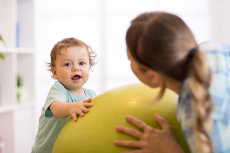 Baby exercises on fitballの写真素材