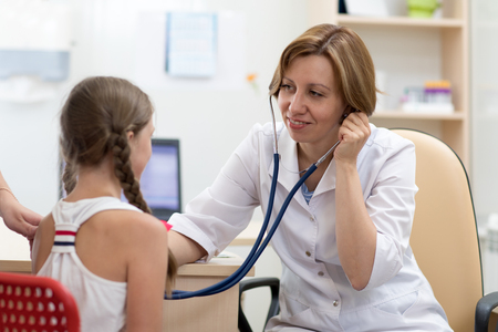 doctor examining child patient with stethoscopeの写真素材