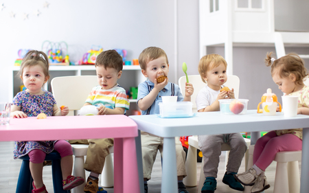 Babies have lunch in nurseryの写真素材