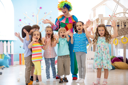 children group with clown celebrating birthday partyの写真素材