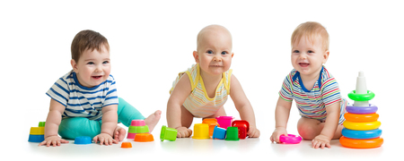 Nursery babies playing with toys isolated on white backgroundの写真素材