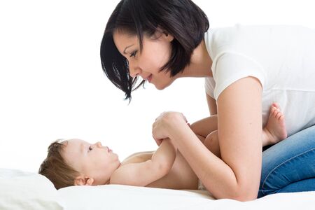 Happy young mother playing with infant babyの写真素材