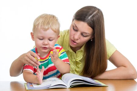 Young woman teacher and little child on private lessonの写真素材