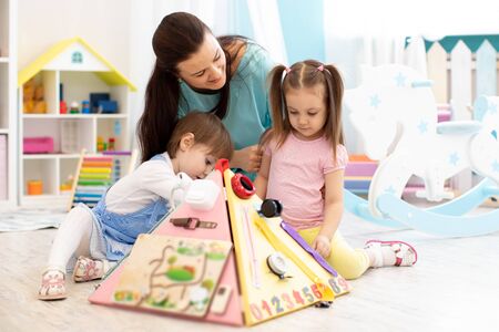 Kids playing with educational toys in kindergartenの写真素材