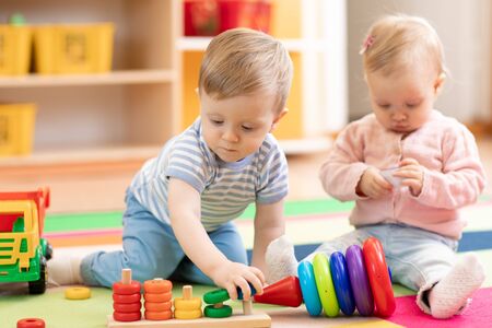 Nursery babies playing with educational toys, early learningの写真素材