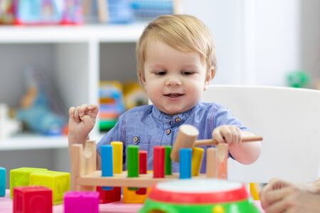 kid boy plays with educational toy indoorsの写真素材