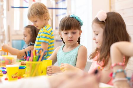 Group of preschool kids hands working in day care centerの写真素材