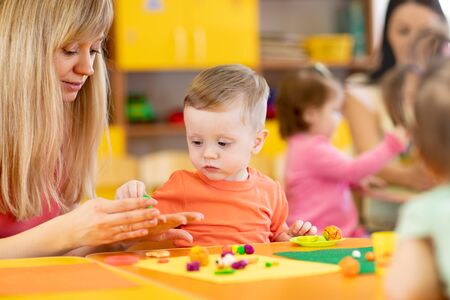 Group of kids on art classes with teachers in kindergartenの写真素材
