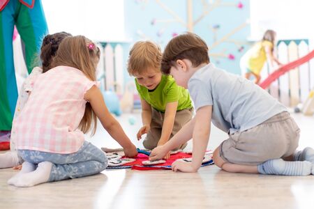 Preschool kids learning how to tell time from clock and set the hands in the correct positionの写真素材