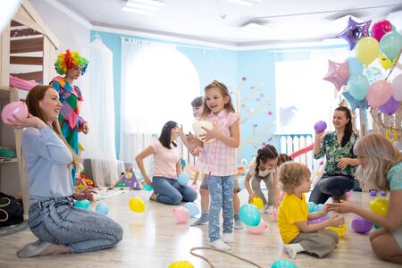Little kids and parents have fun on children birthday partyの写真素材