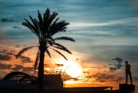 monument silhouette walking man against the sky at sunsetの写真素材