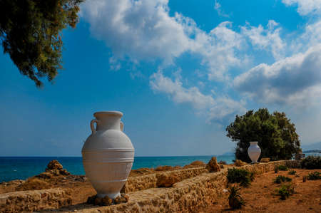the sea shore with golden sand and a Greek vessel in the summer on a sunny dayの写真素材
