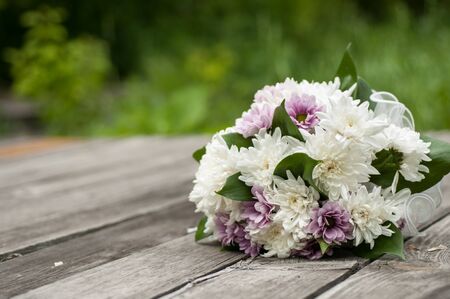 wedding bouquet of asters on the background of old wooden boardsの写真素材