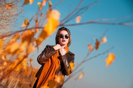 blonde girl with short haircut on nature background in autumn, Chelyabinsk Region, Russia