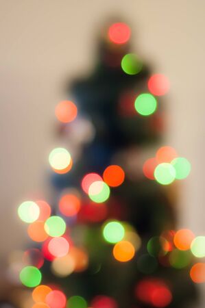 blurred background of a Christmas tree with garlandsの写真素材