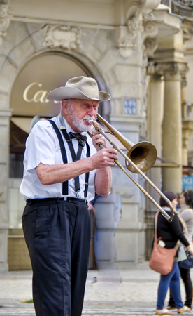 men on a city street playing a trumpet on the Old Town Square, the Czech Republic in the summer of September 1, 2011のeditorial素材