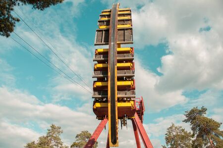 Big swing with people in an amusement parkの写真素材