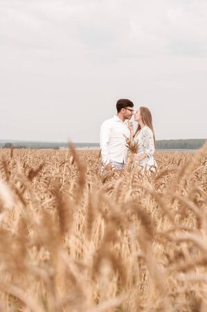 Young couple in a wheat field on a sunny dayの写真素材