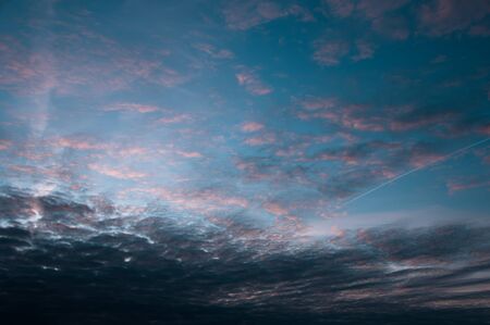 Beautiful blue sky with white clouds and vivid colors at sunset without horizon, background imageの写真素材