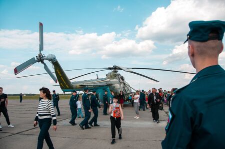 Chelyabinsk, Shagol village, Russia September 14, 2019: Russian green military helicopter on the observation deck at the Aviation Day holiday with a crowd of people on a sunny autumn dayのeditorial素材