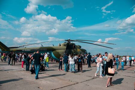 Chelyabinsk, Shagol village, Russia September 14, 2019: Russian green military helicopter on the observation deck at the Aviation Day holiday with a crowd of people on a sunny autumn dayのeditorial素材