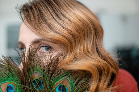 Woman with long brown hair and elegant hairstyle in retro style of wavy hair in a beauty salonの写真素材