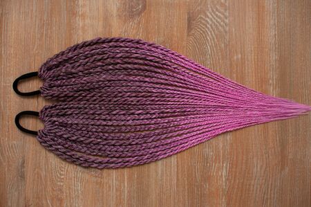 Handmade rubber band made of artificial colored hair braided in pigtails