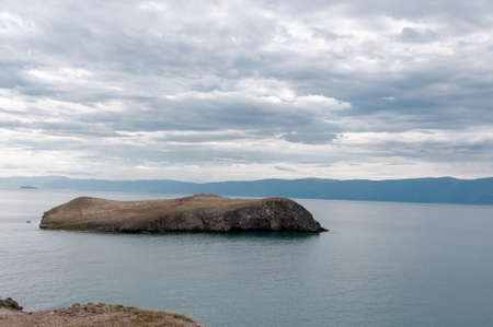 Cape on Lake Baikal and beautiful cloudy sky on a summer dayの写真素材