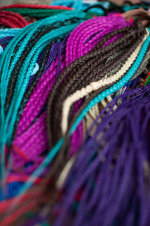Colored braids on an elastic band for hair, accessory close-up