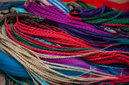 Colored braids on an elastic band for hair, accessory close-upの写真素材
