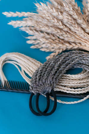 Decorative hair accessory of natural light color, elastic band with small colored braids, handmade...