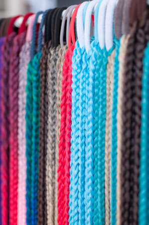 Group of hair accessories, elastic bands with small colored braids, handmade close-upの写真素材