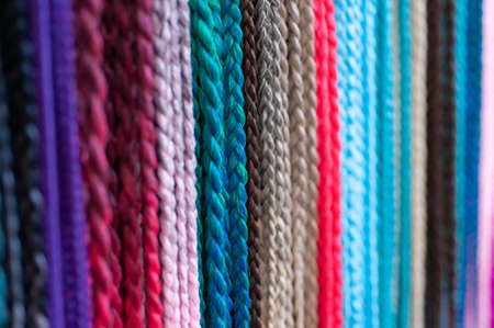 Group of hair accessories, elastic bands with small colored braids, handmade close-upの写真素材