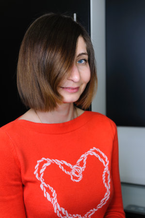 Portrait of young woman with blue eyes with bob haircut in casual clothes indoorsの写真素材