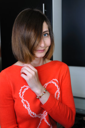 Portrait of young woman with blue eyes with bob haircut in casual clothes indoorsの写真素材