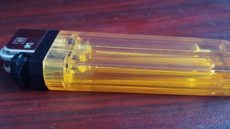 Lighter on a wooden table, close-up, top view. lighter on the wooden table, can be used as a backgroundの写真素材